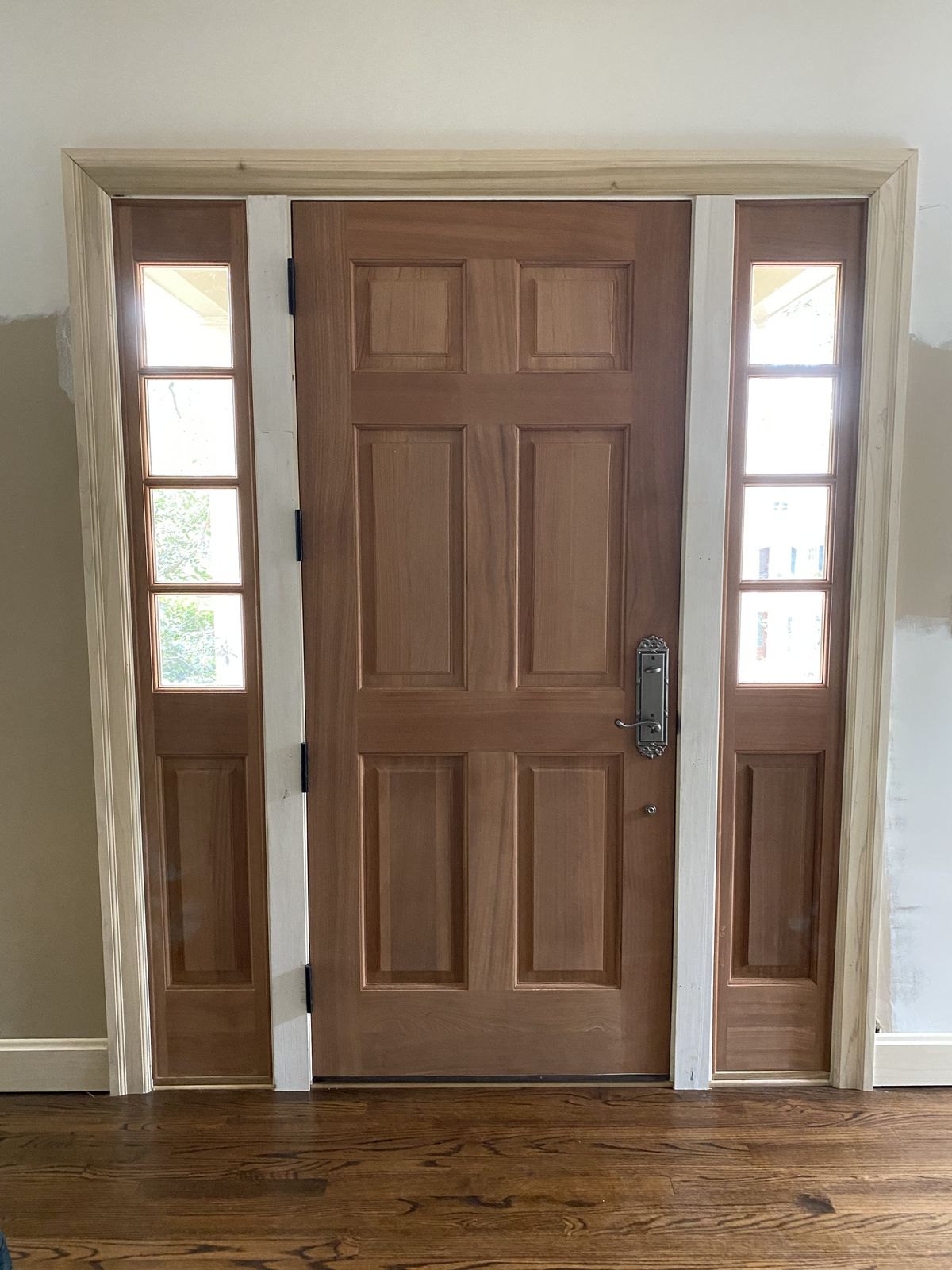 Mahogany six-panel entry door with sidelights and new jamb and trim, installed in a Huntsville home