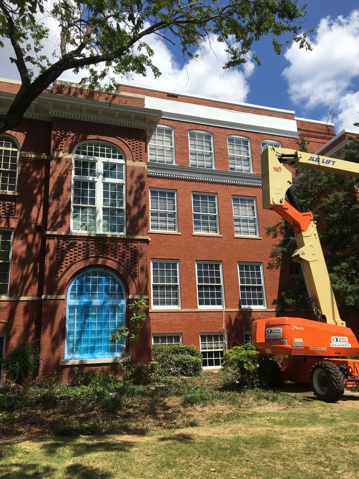 Window replacement on a historic multi-story brick building using a boom lift