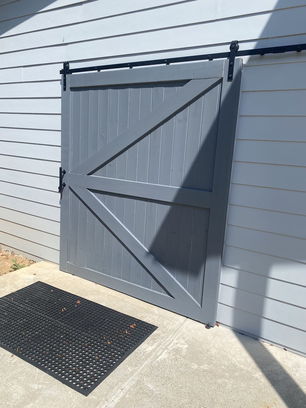 Custom-built sliding barn door on exterior track hardware